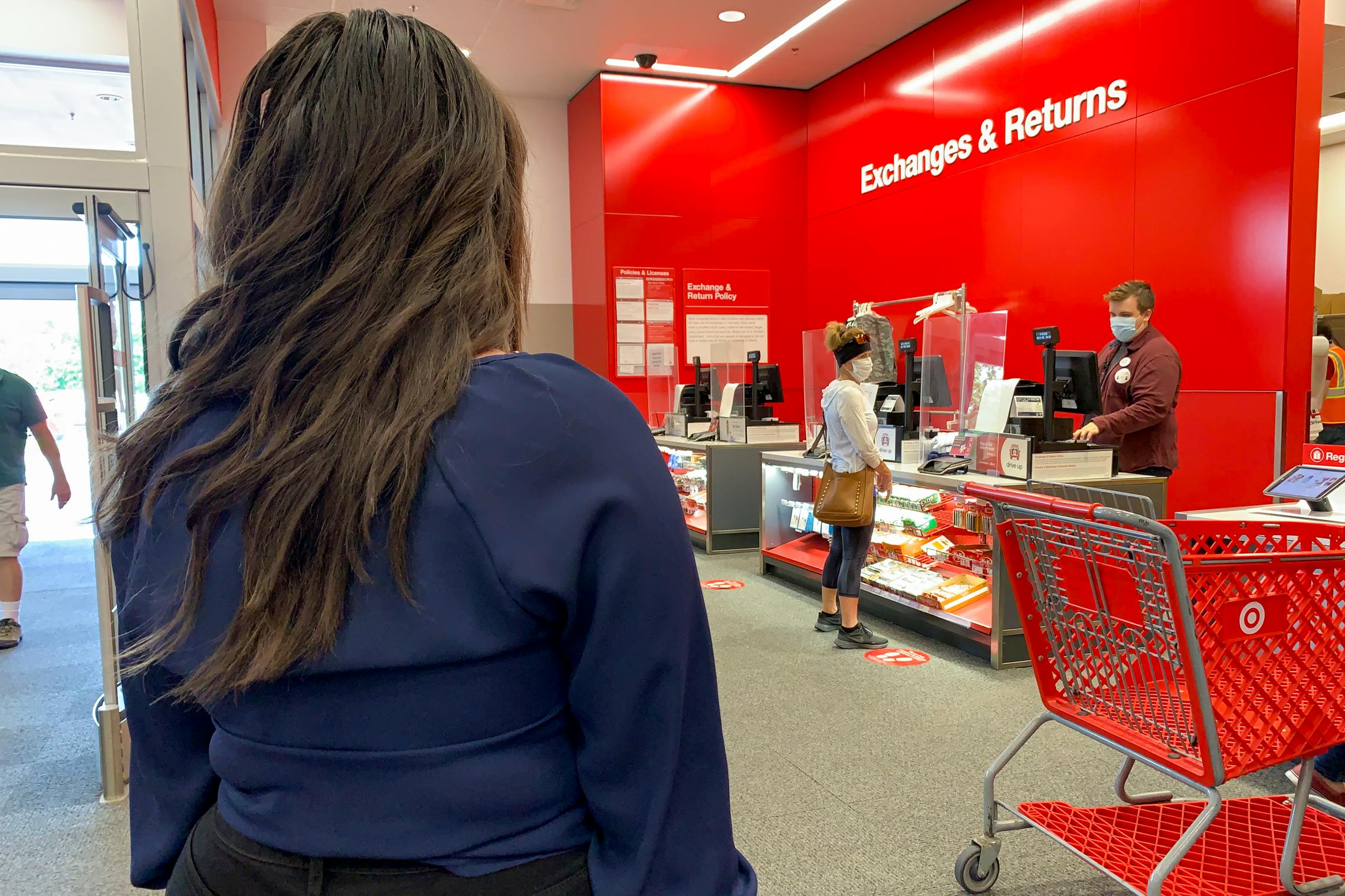 A woman standing in line at the Target return counter.