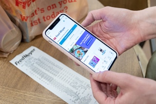 Someone holding a phone with the Ibotta open about to scan a receipt