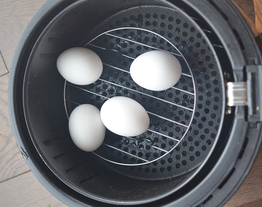 hard boiled eggs on a rack in an air fryer