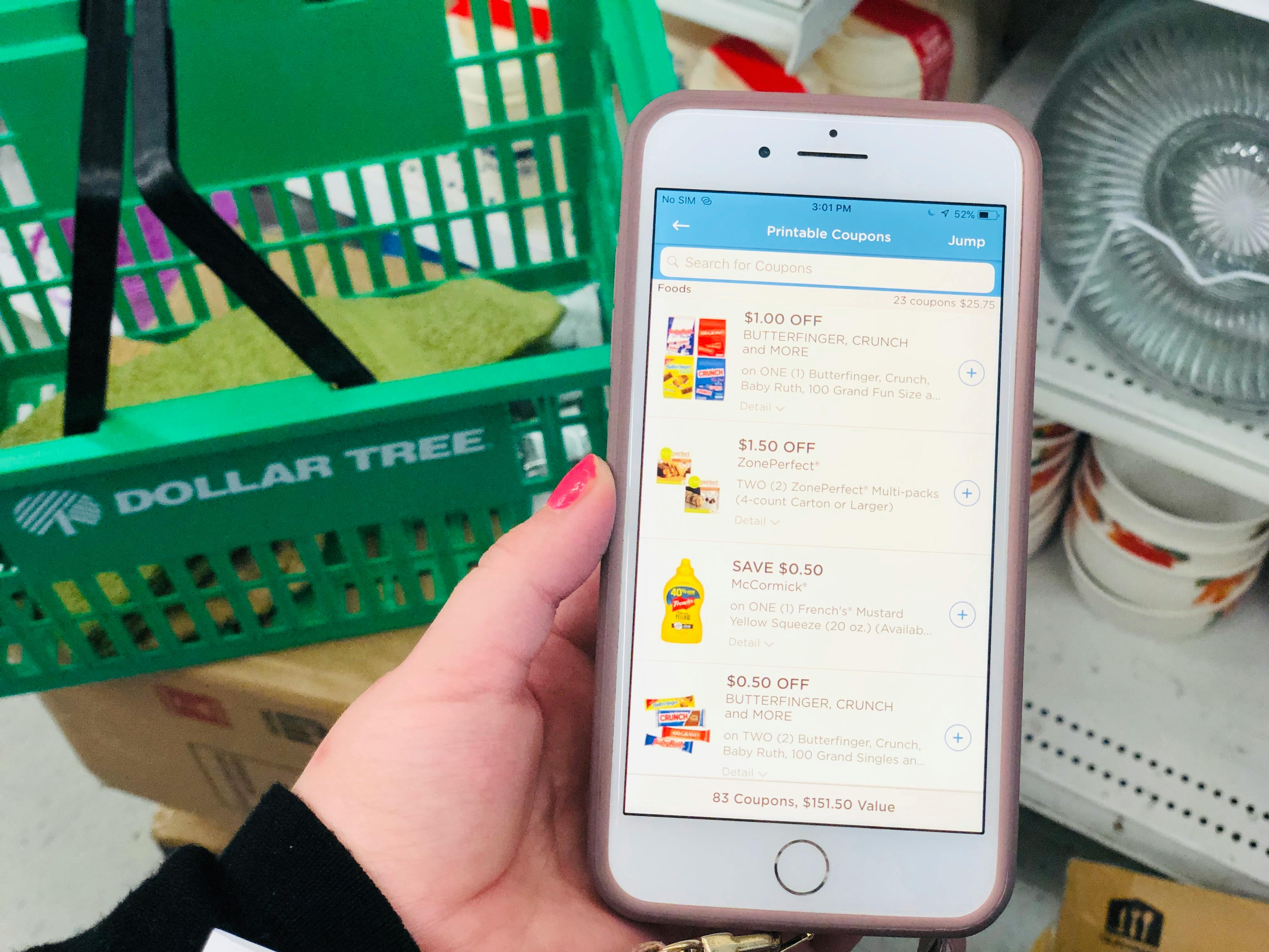 someone holding phone with coupons.com open in dollar tree
