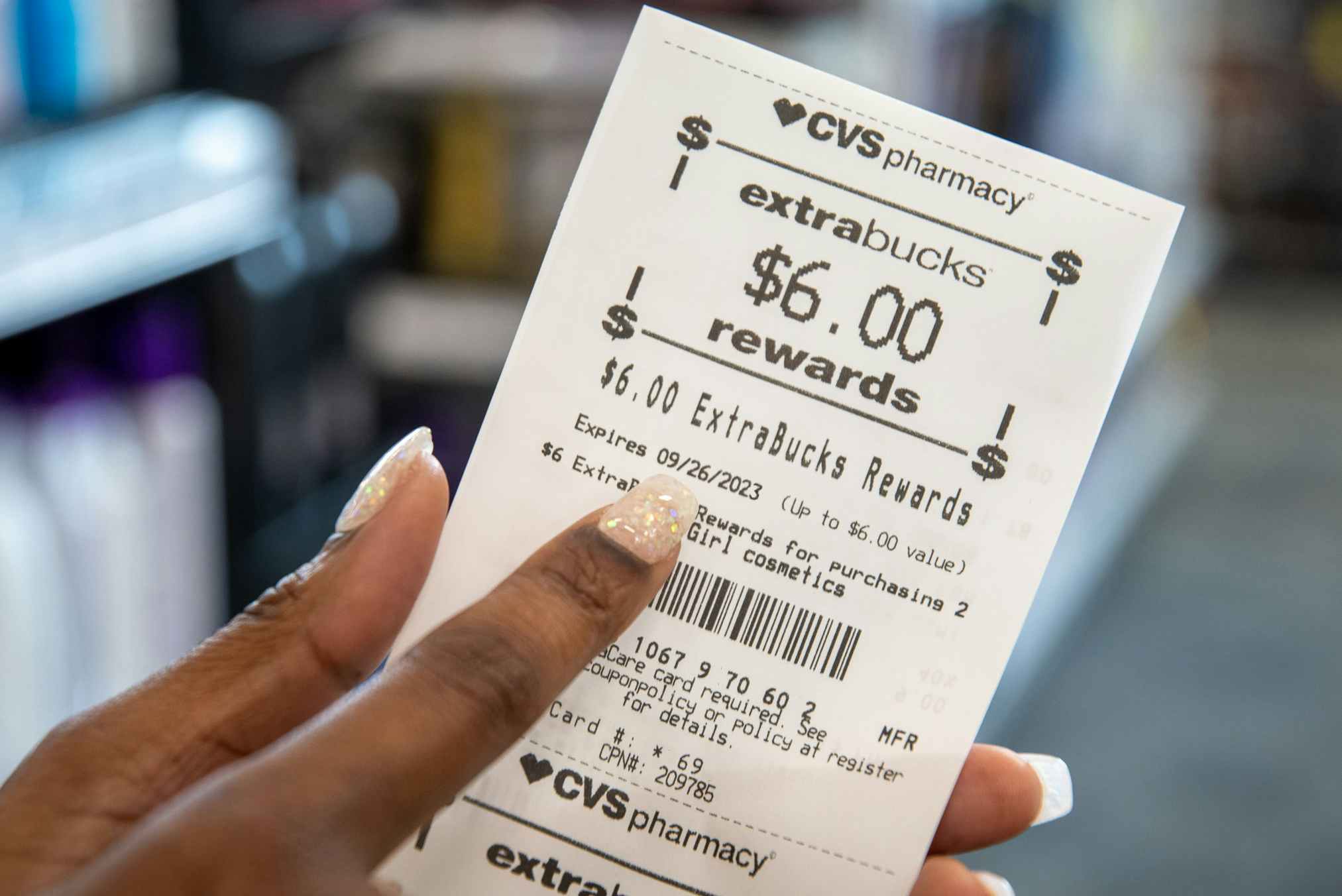 Someone pointing to the expiration date on a CVS Rewards receipt