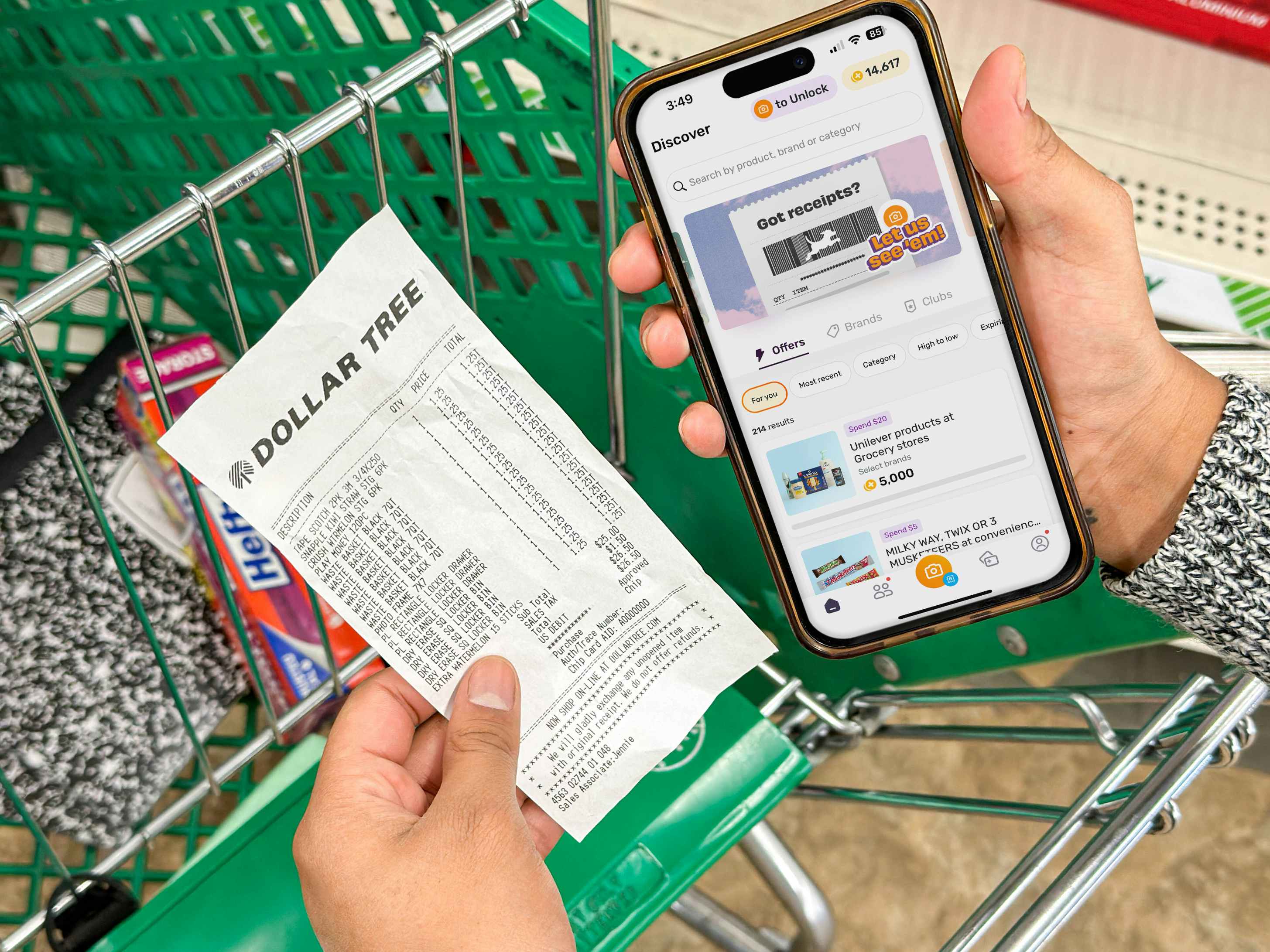 a person holding an iphone with a coupon app in the dollar tree store 