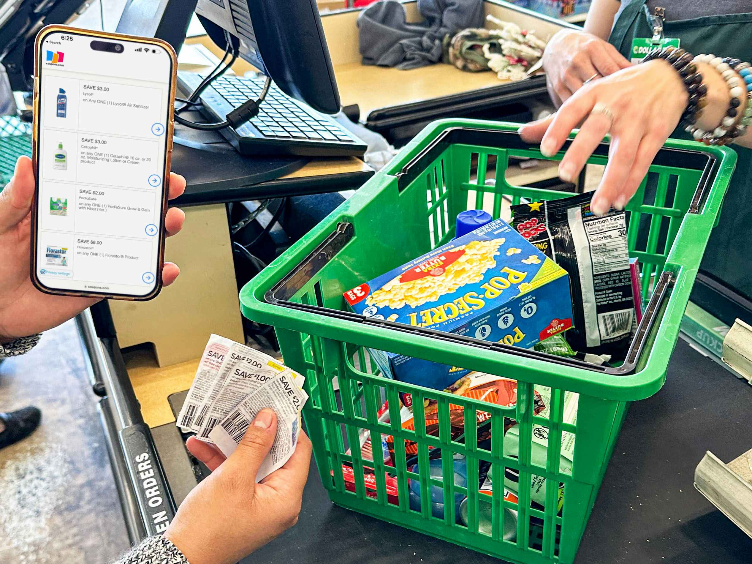 a person holding an iphone with a coupon app in the dollar tree store