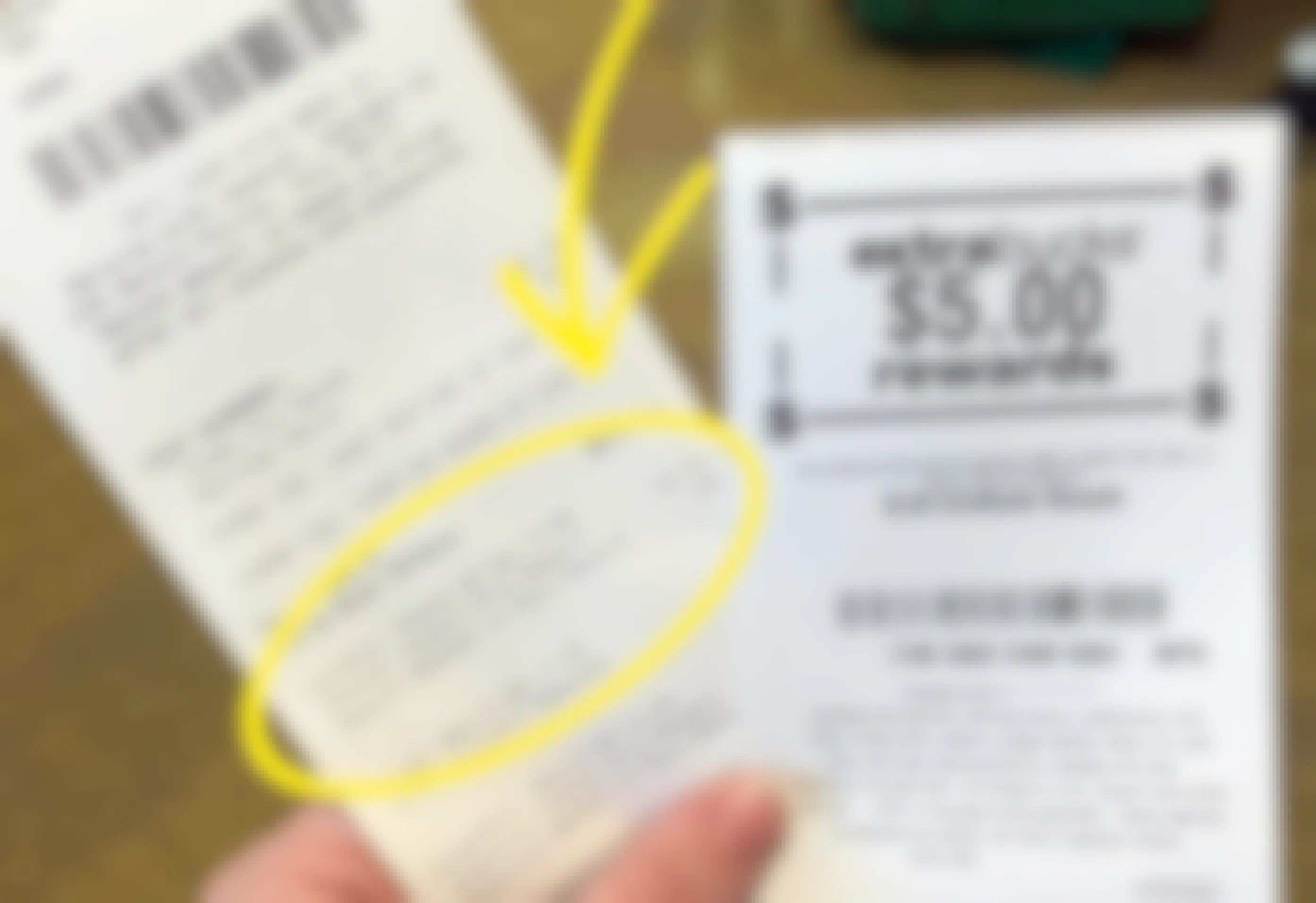 Someone holding a CVS receipt with a $5 ExtraBucks rewards receipt