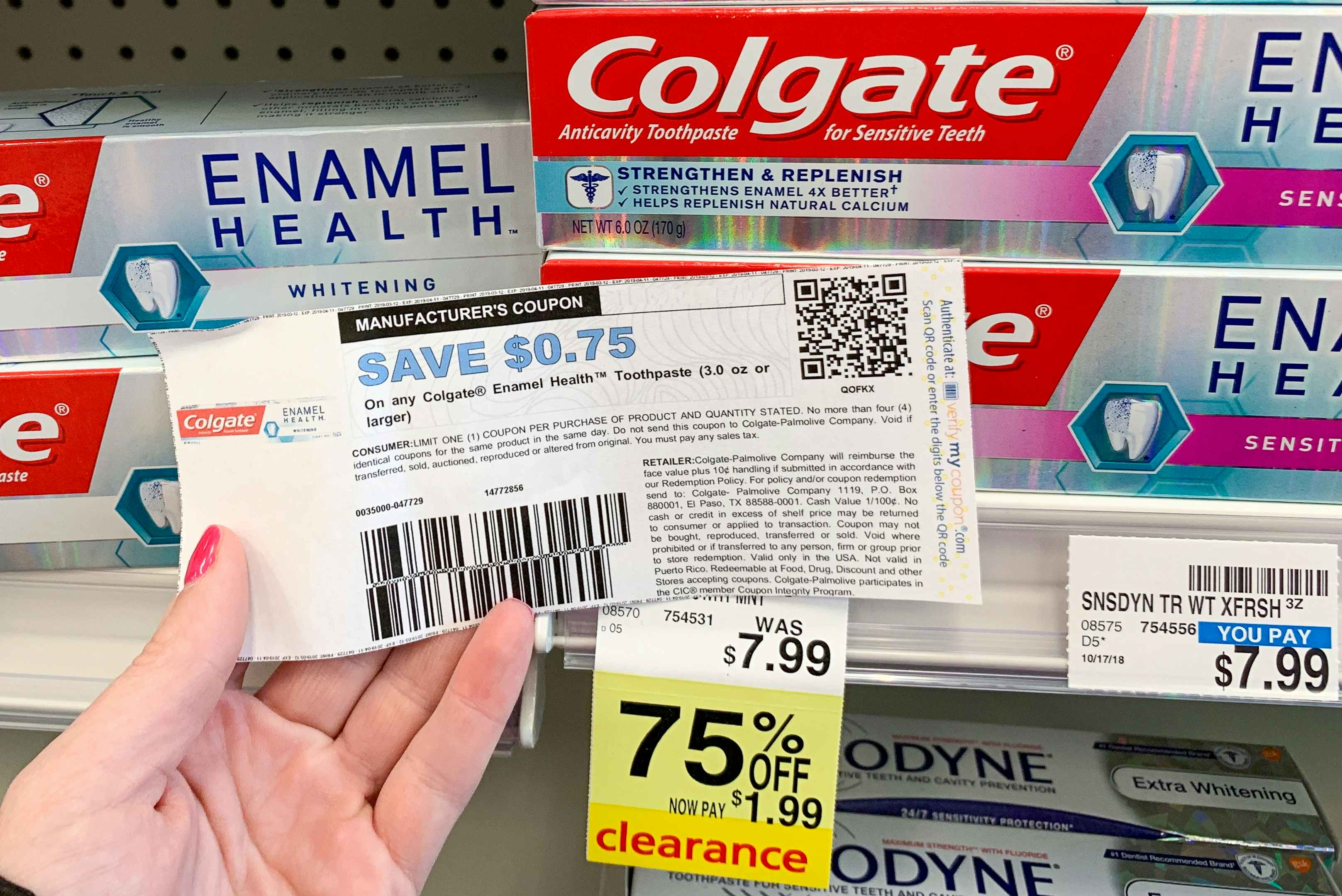 Someone holding a coupon next to a product on clearance at CVS