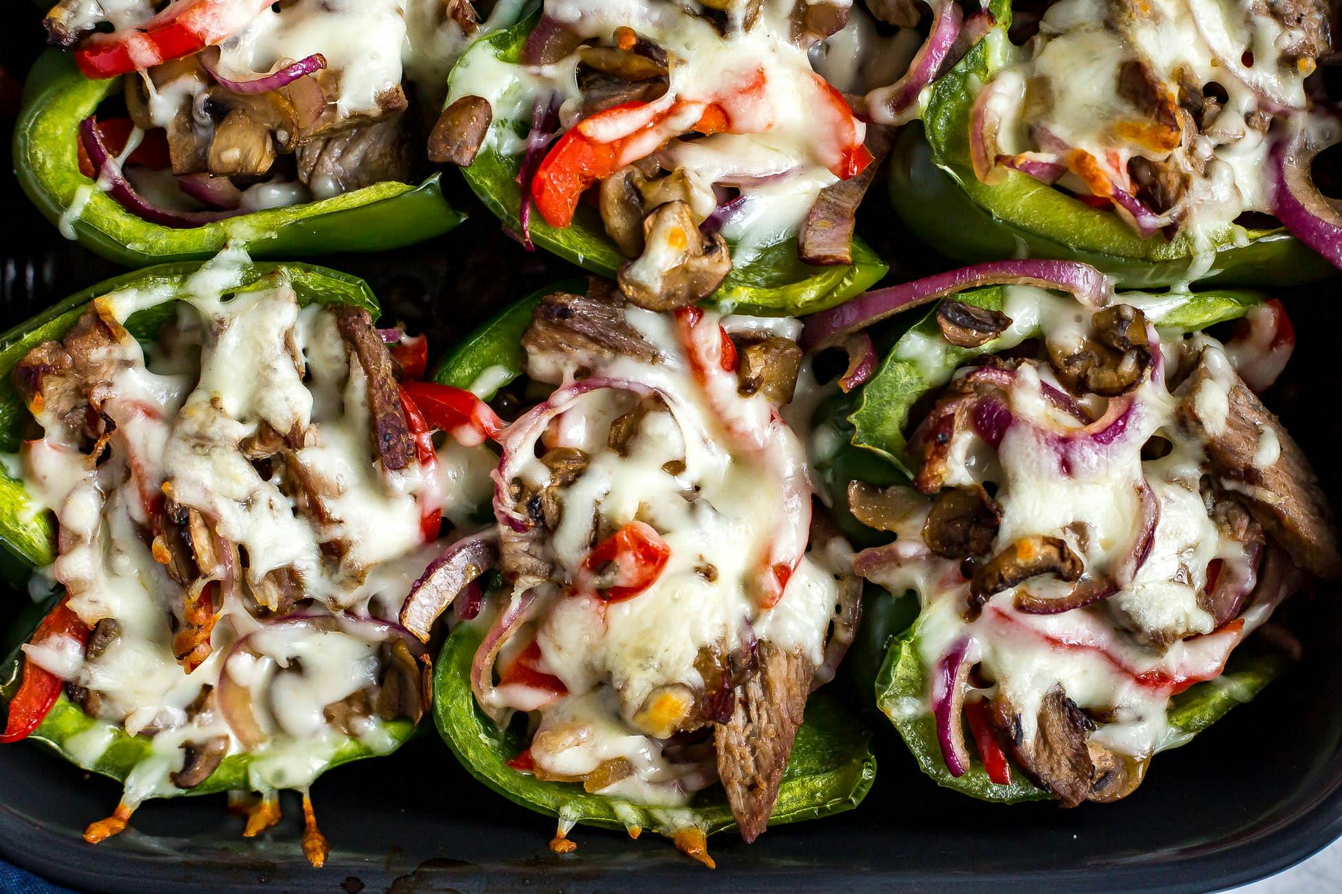 Green bell peppers stuffed with meat, veggies and cheese