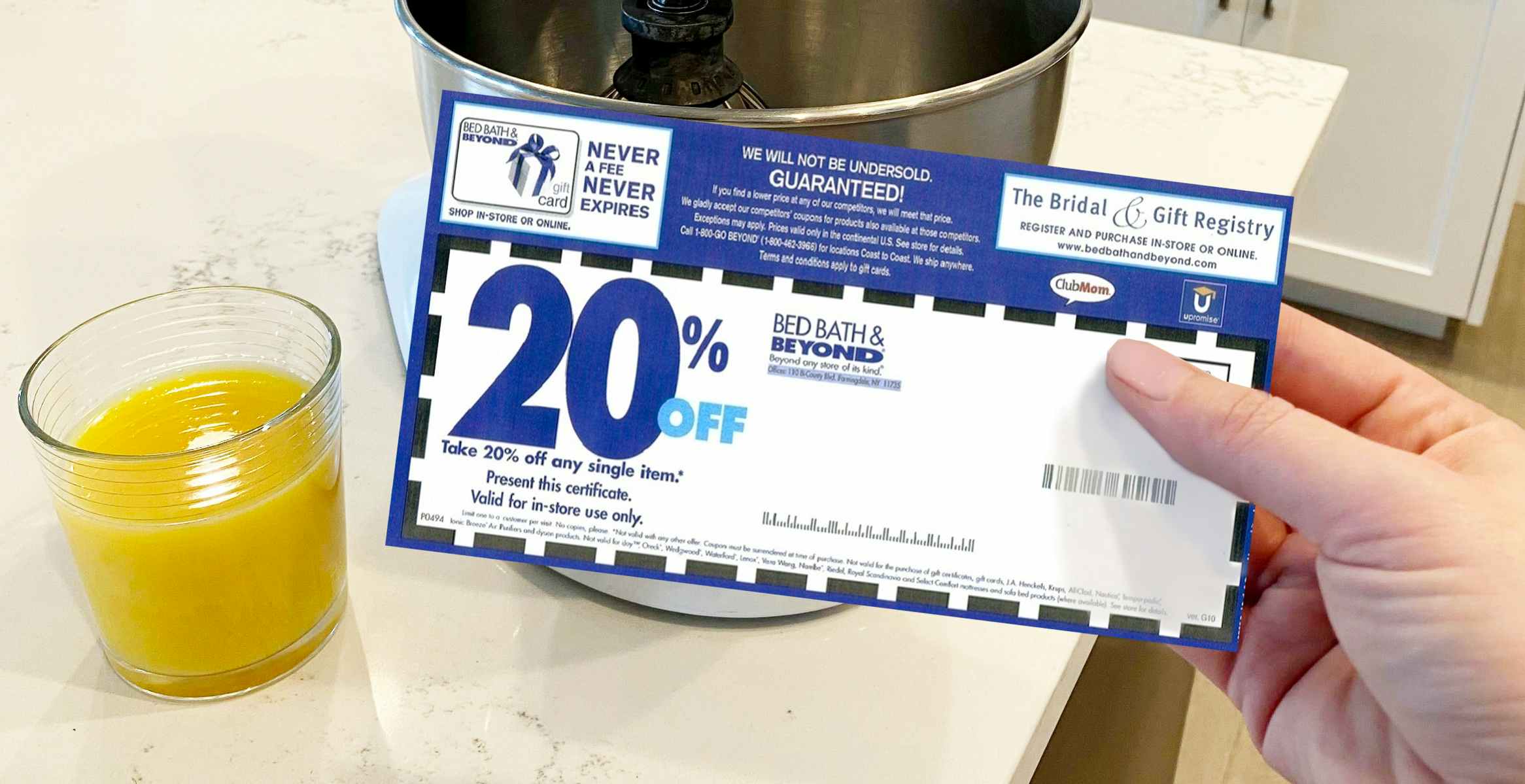 A Bed Bath and Beyond coupon in front of a Kitchenaid