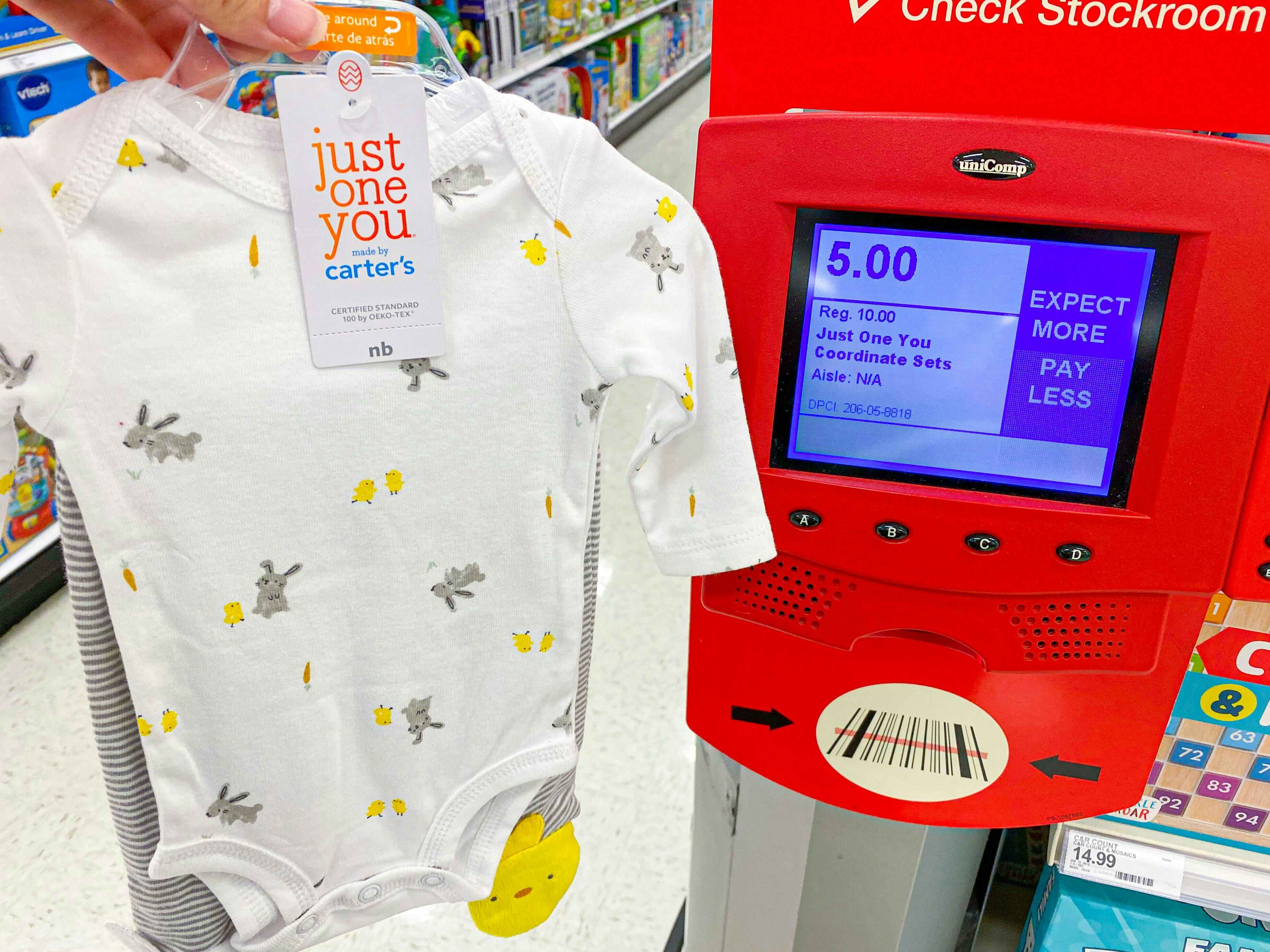 baby clothes being held in front of target scanner showing sales price