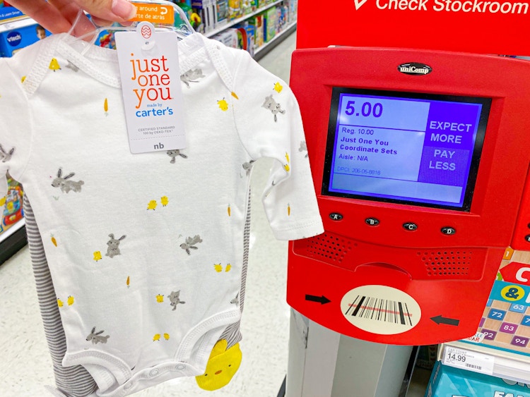 baby clothes being held in front of target scanner showing sales price
