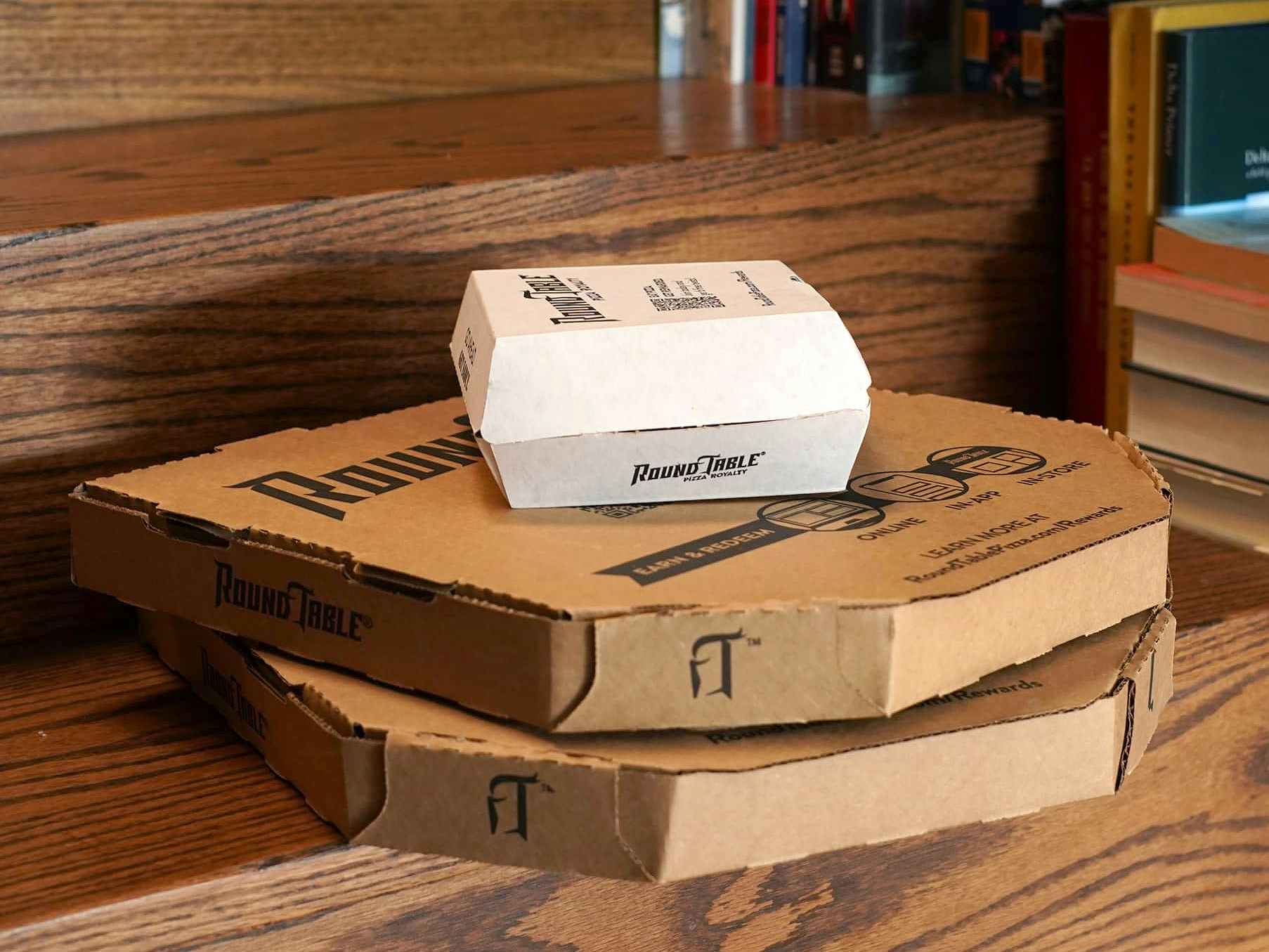 stacked round table pizza boxes and appetizer box