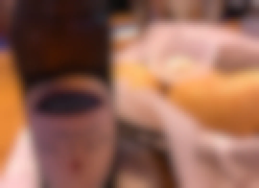 A close-up of a bottle of Michelob Ultra beer next to a basket of bread and butter on the table at Texas Roadhouse.