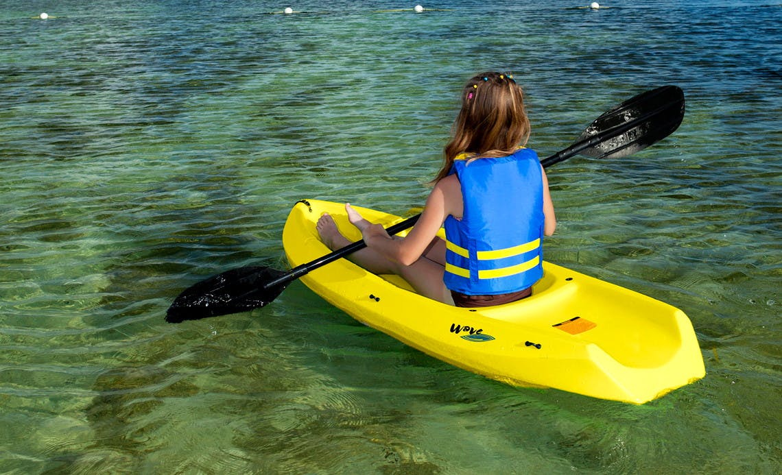 child paddling on a paddleboard in the water