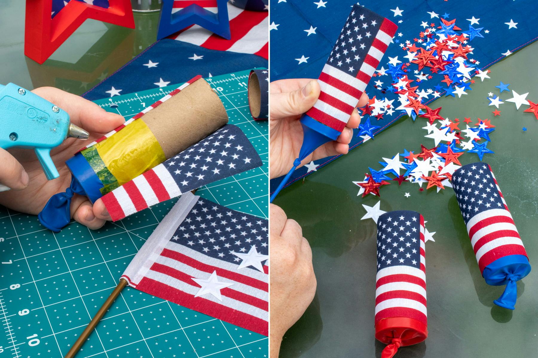 A person's hands using a hot glue gun to glue a small American flag around a toilet paper roll that has a cut balloon taped to the end, and three completed confetti poppers, on a table with red, white, and blue confetti scattered around.