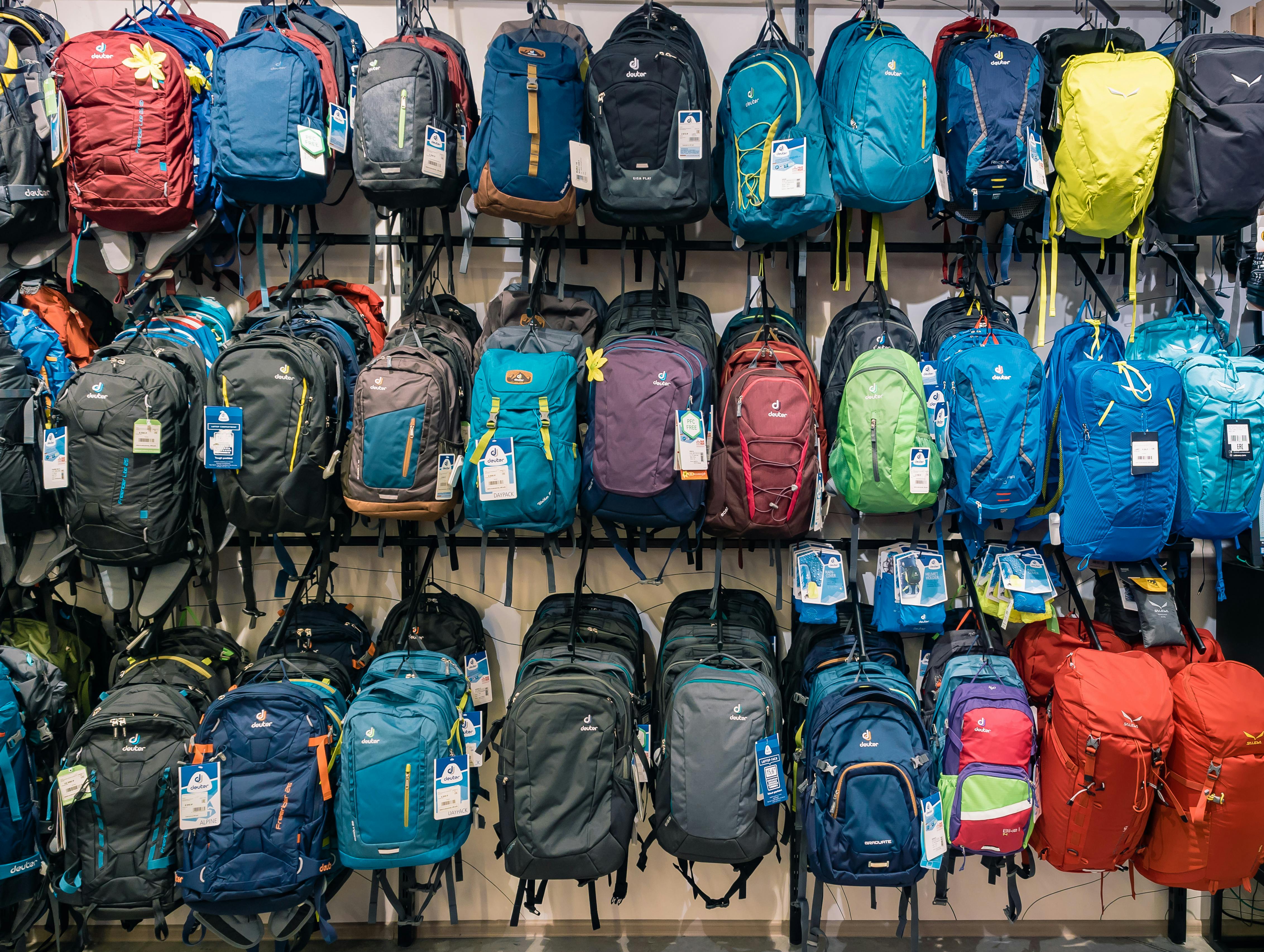 A wall of camping backpacks in a retail store