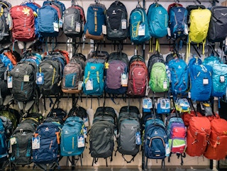 A wall of camping backpacks in a retail store