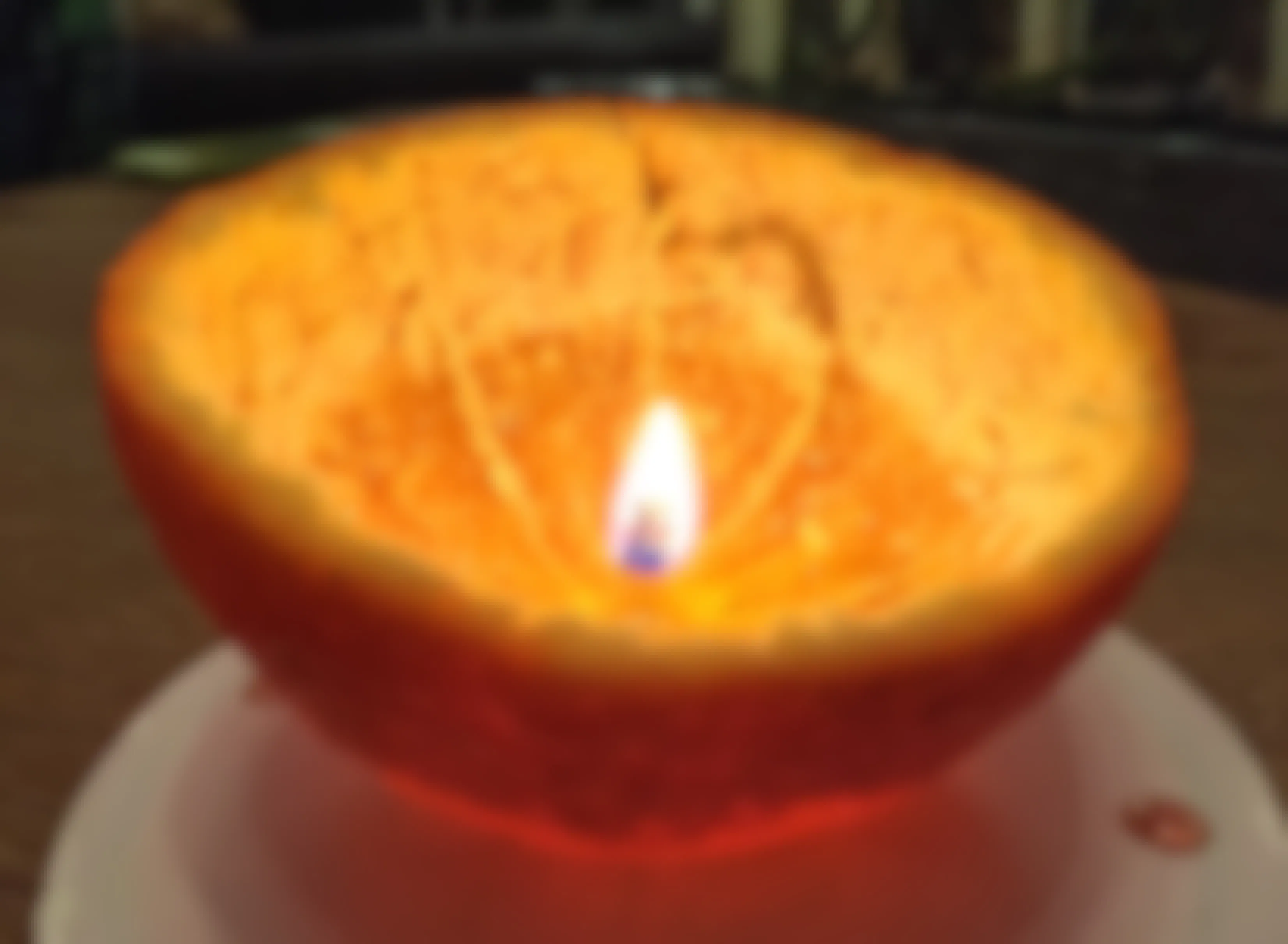An orange peel turned into a candle with the inner stem as the wick