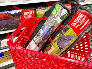Two Coleman camping tents sitting in a Target shopping cart in the camping gear aisle at Target.