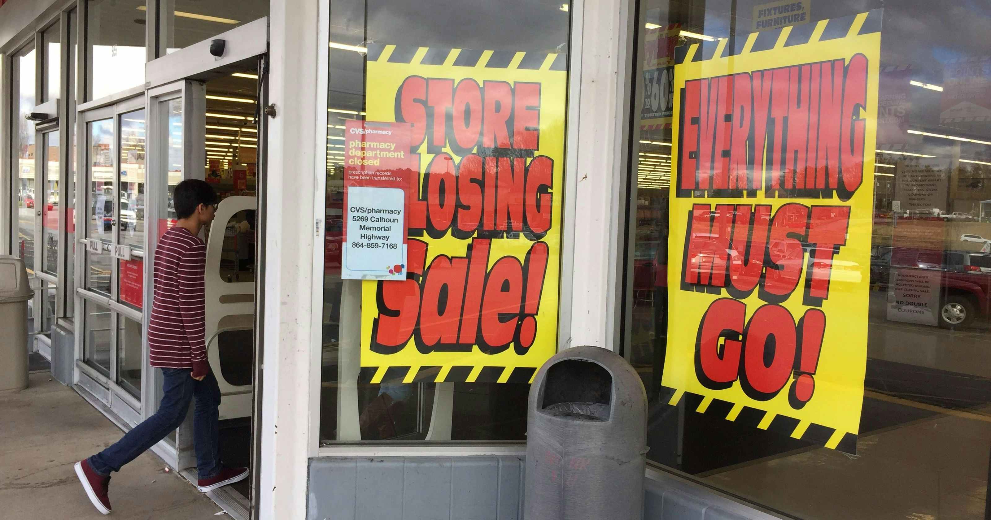 Store closing signs in a window of a store