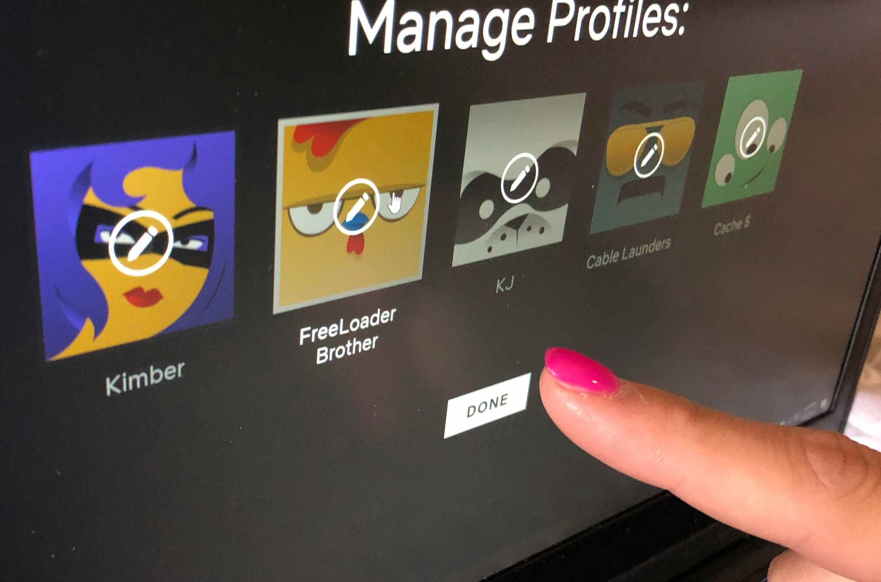A person's finger pointing to a profile displayed on Netflix that is titled "Free Loader Brother