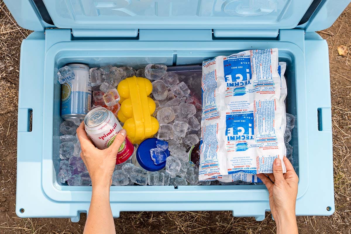A cooler packed with food, ice, and ice packs