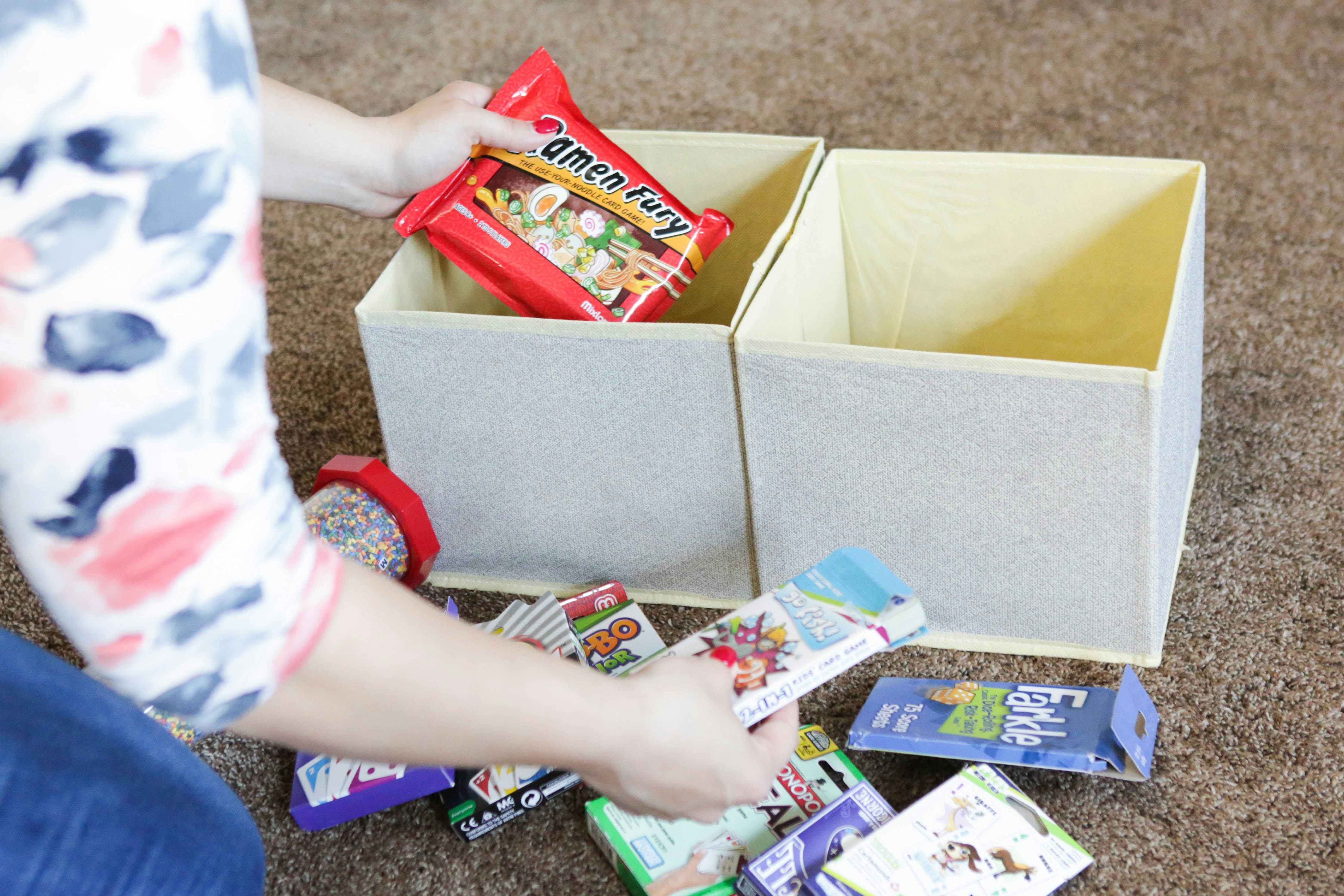 A person organizing snacks into Dollar Tree Storage cubes