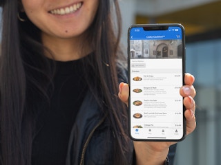 Someone holding up their phone displaying the Universal Orlando app, about to place a mobile order.