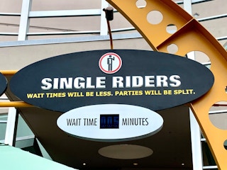 A sign for single riders outside of a ride at Universal Orlando