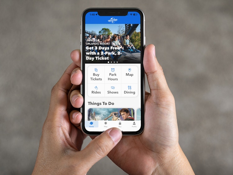 a person looking at the universal studios mobile app on their iphone