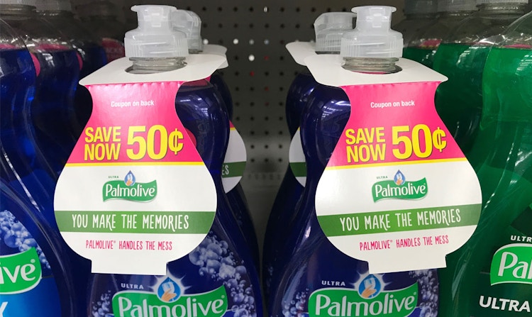 Two rows of bottles of Palmolive dish soap with hang tag coupons on them sitting on a store shelf.