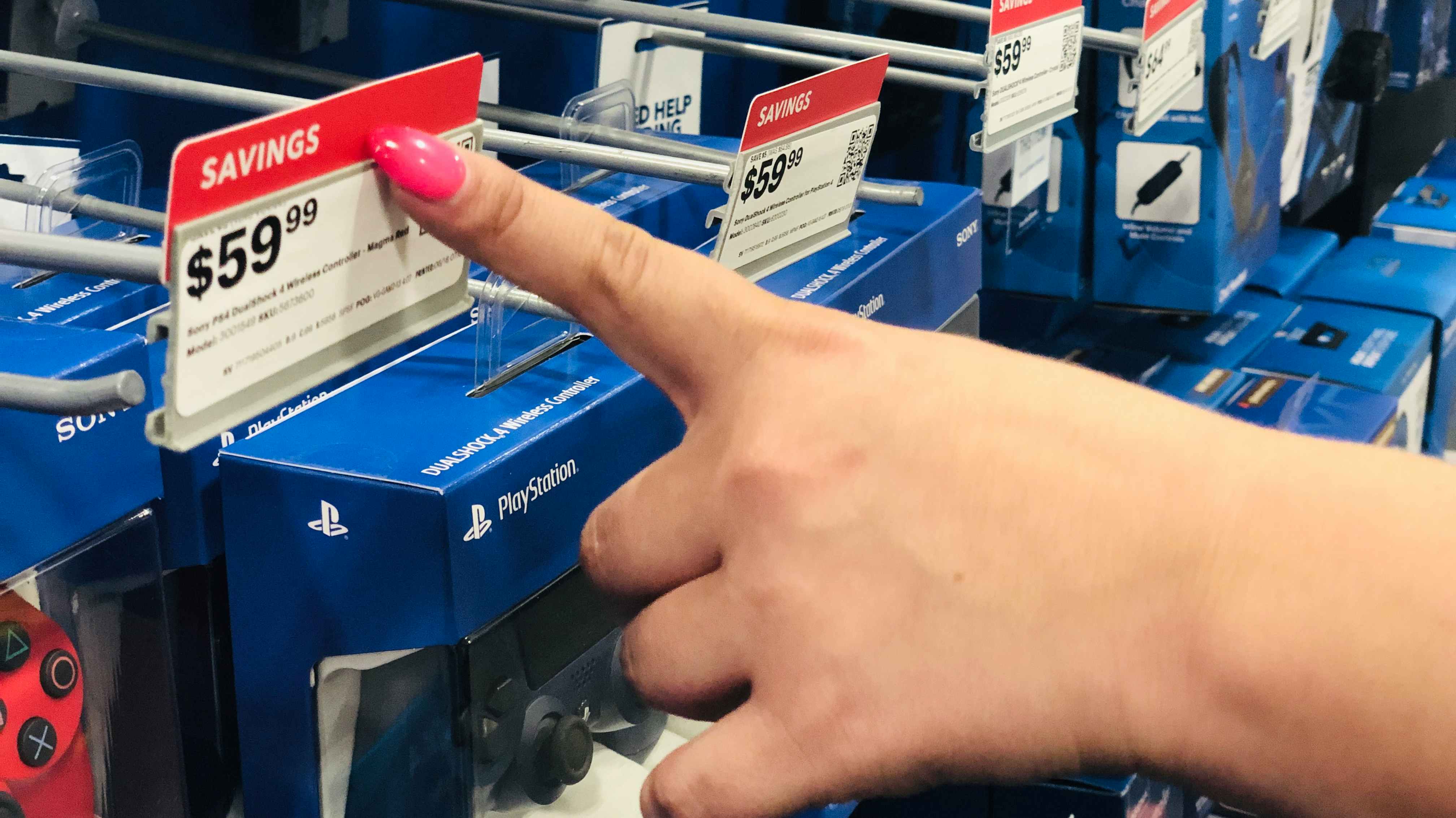 hand points to best buy red tag