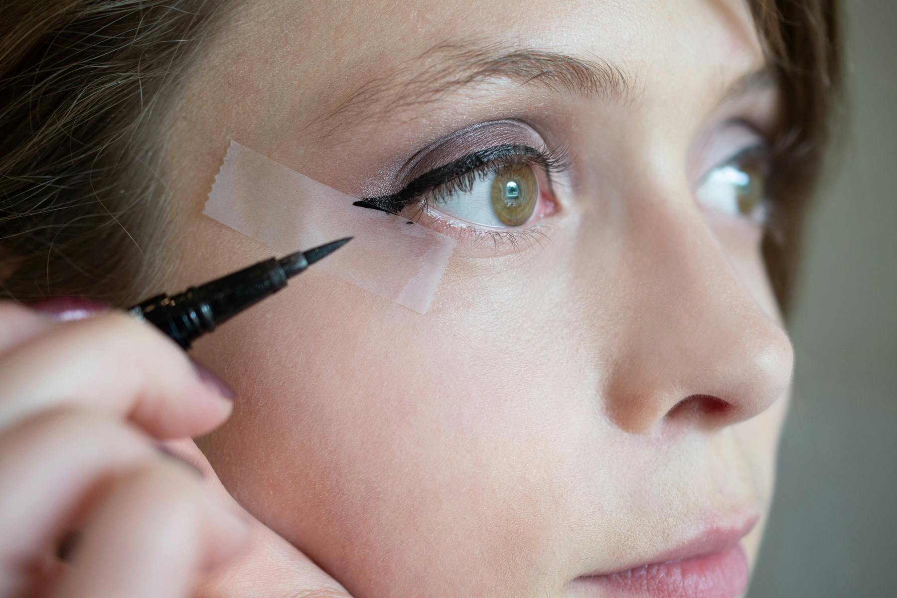 Use tape to perfect winged eyeliner.