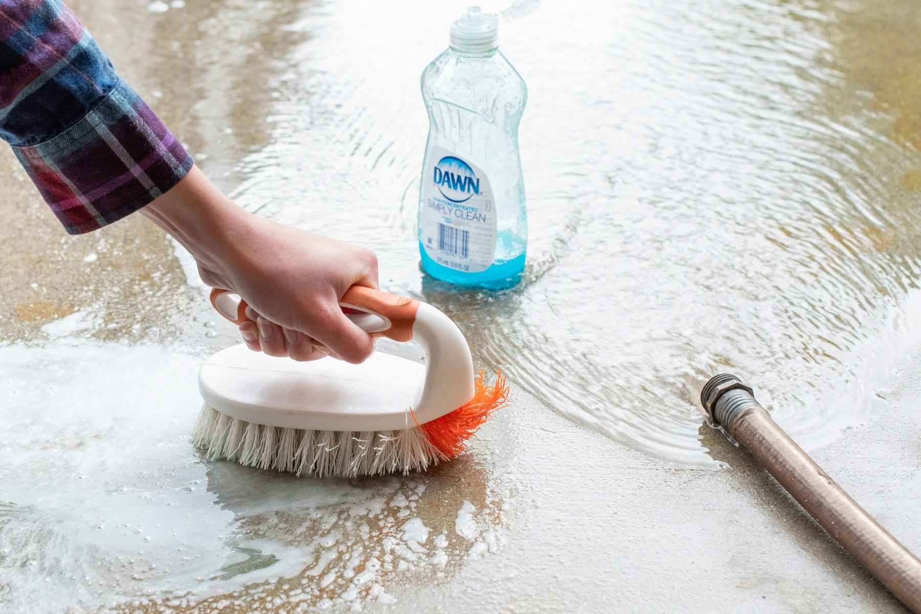 Remove oil stains from concrete with Dawn dish soap.