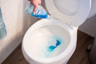 Dawn soap being poured into a toilet.