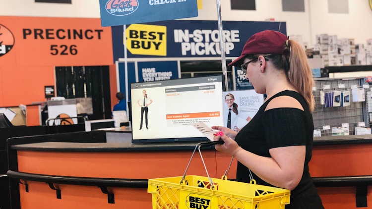 woman stands in front of the best buy geek squad desk