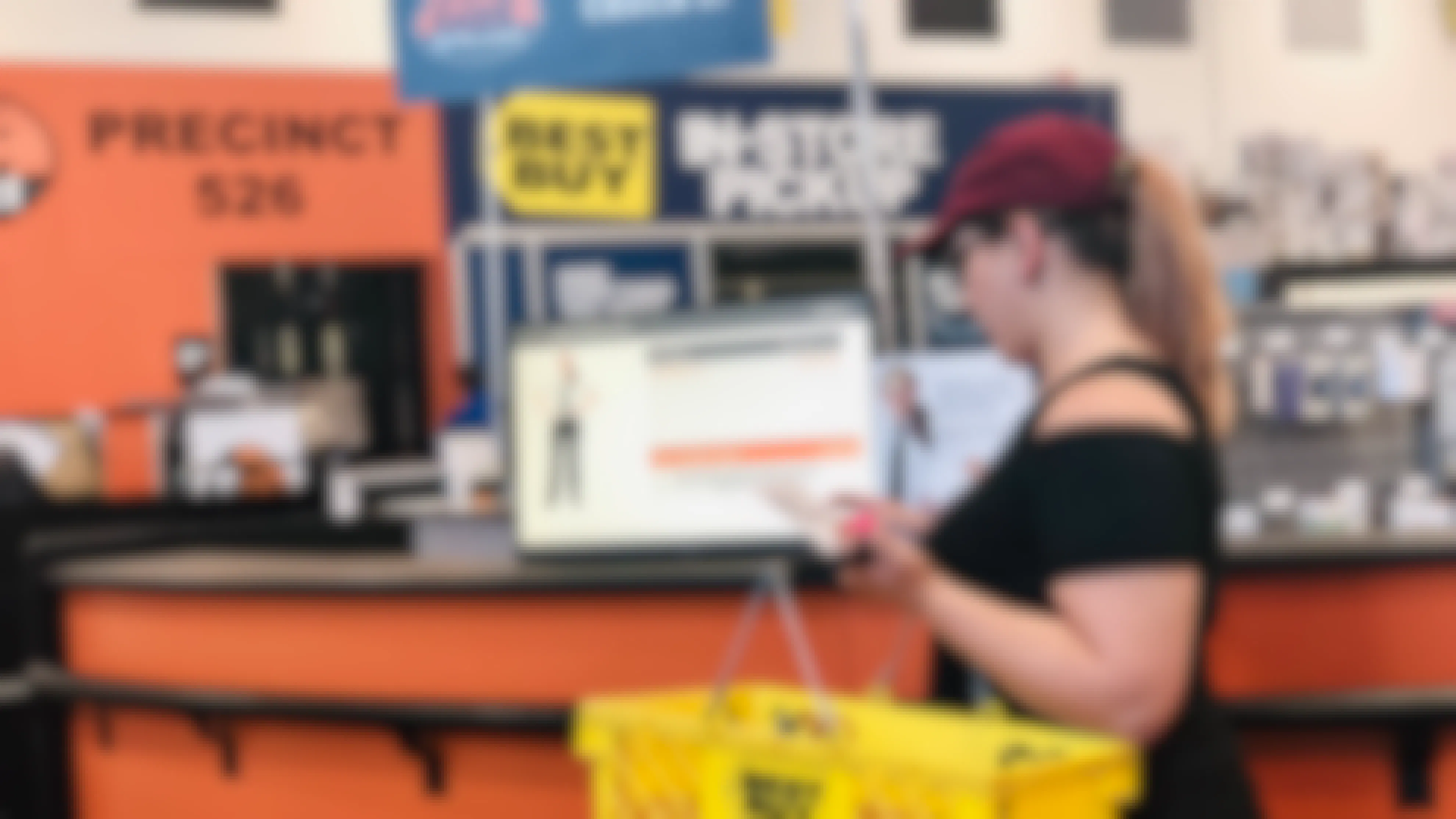 woman stands in front of the best buy geek squad desk