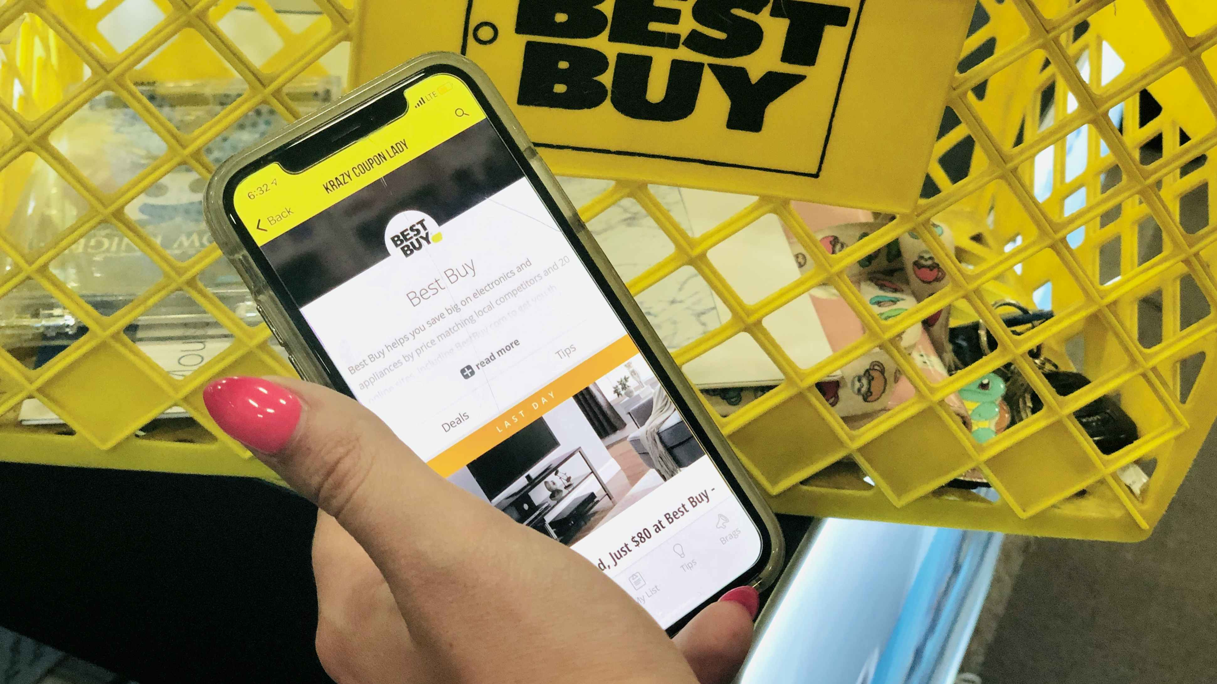 hand holds an iphone open to the KCL app with Best Buy selected