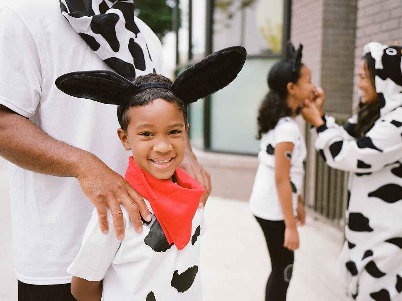 family wearing cow costumes for chick-fil-a cow appreciation day