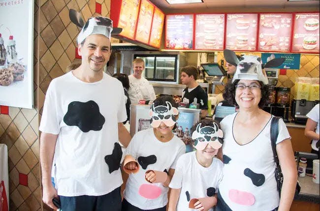 Family dressed up like cows for chick-fil-a cow appreciation day.