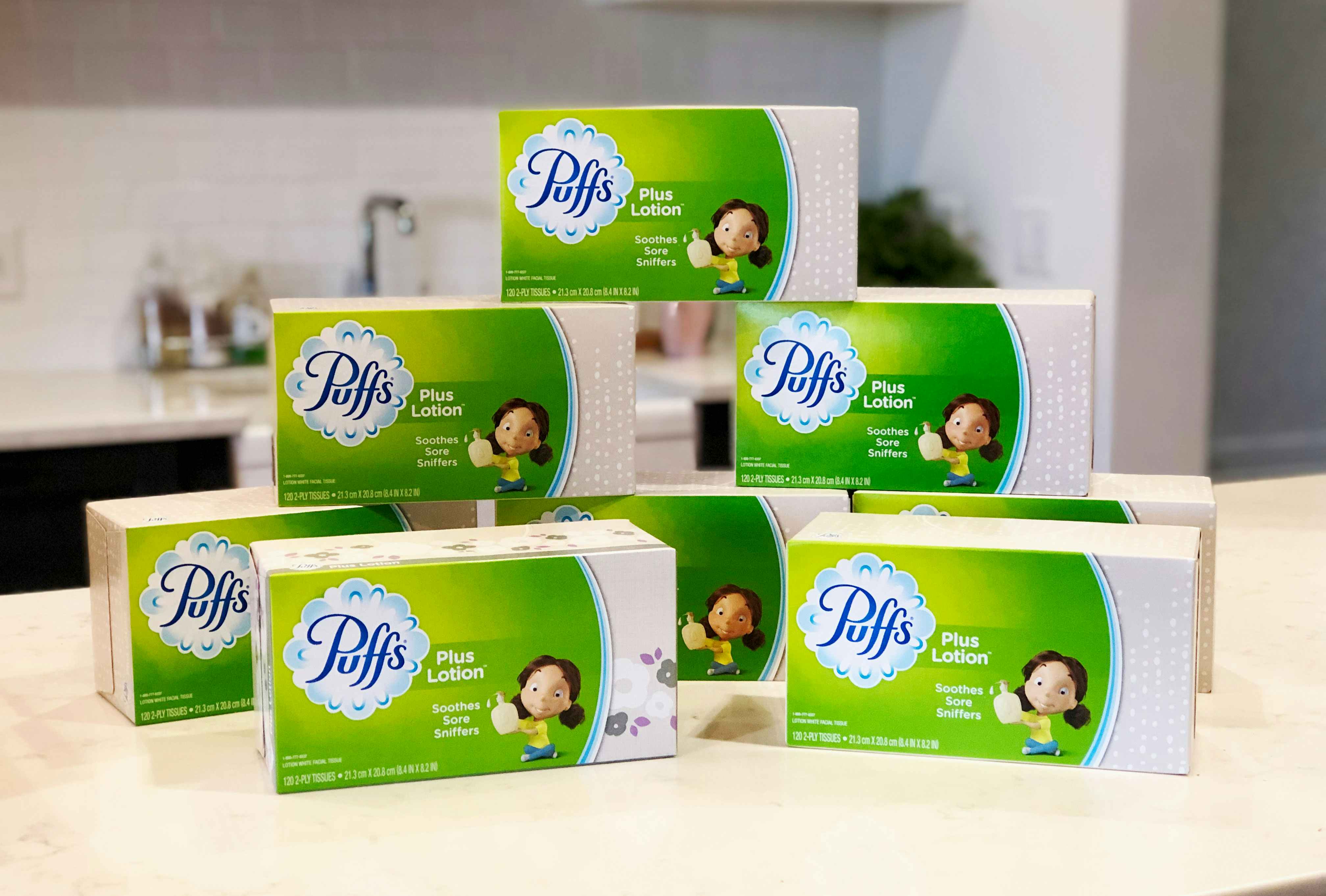 a pack of puffs plus lotion boxes on a table