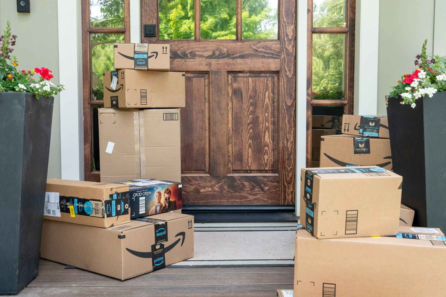 front porch step filled with Amazon prime delivery boxes