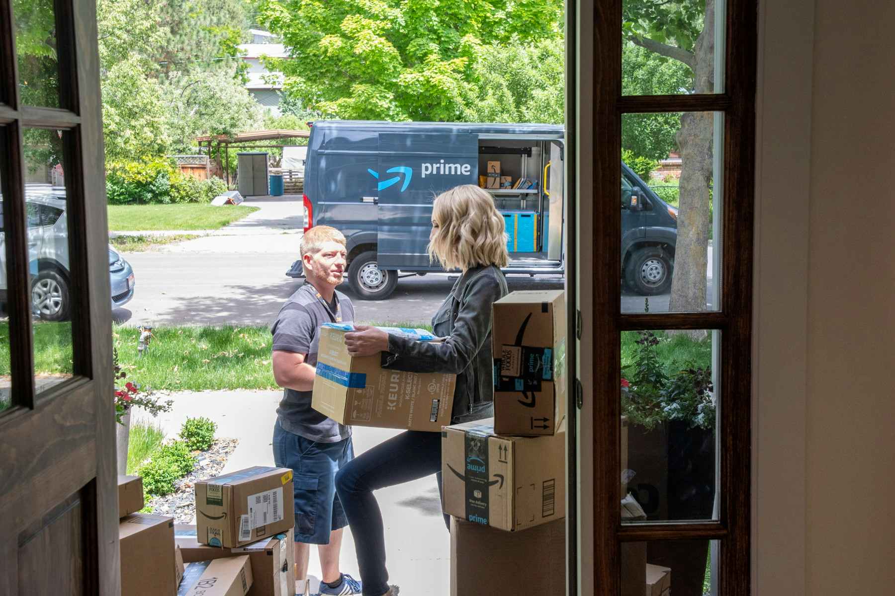 woman accepts amazon delivery at her front door