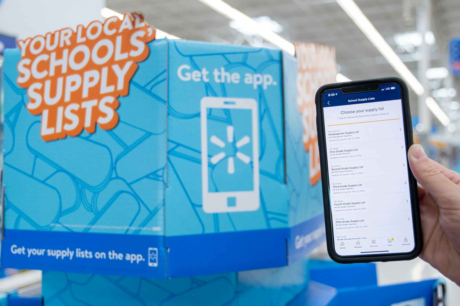 A person's hand holding up their phone, showing the Back-to-School shopping school list on Walmart app.