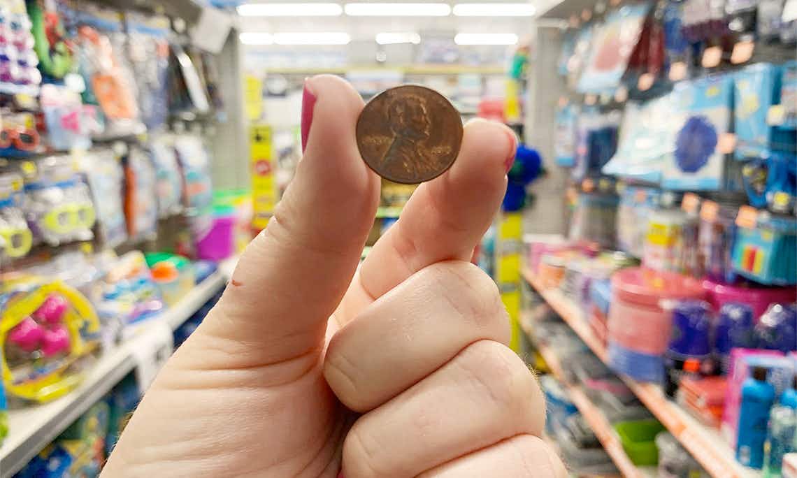 A person holding a penny.