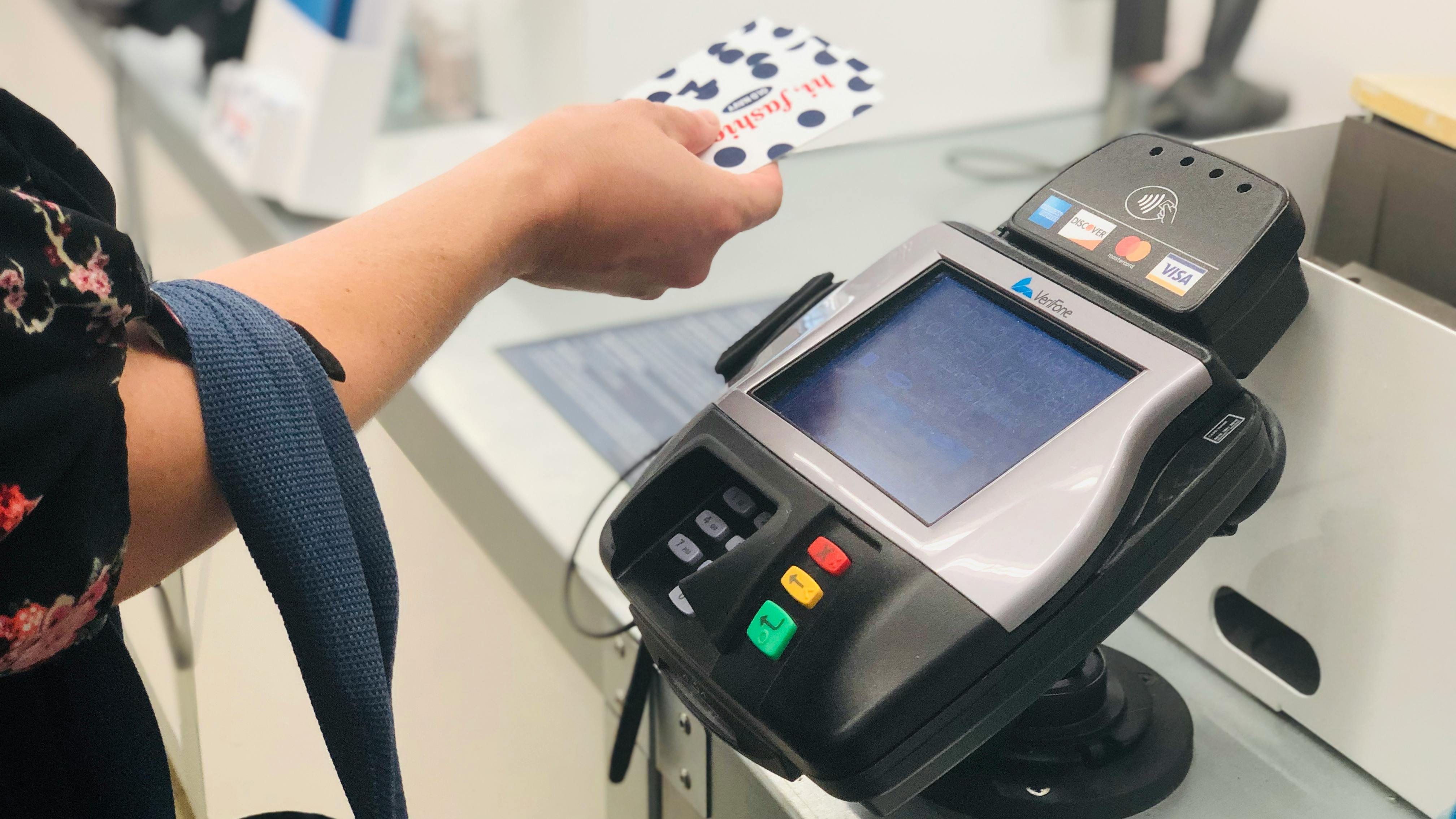 A person holding old navy gift cards near the old navy checkout