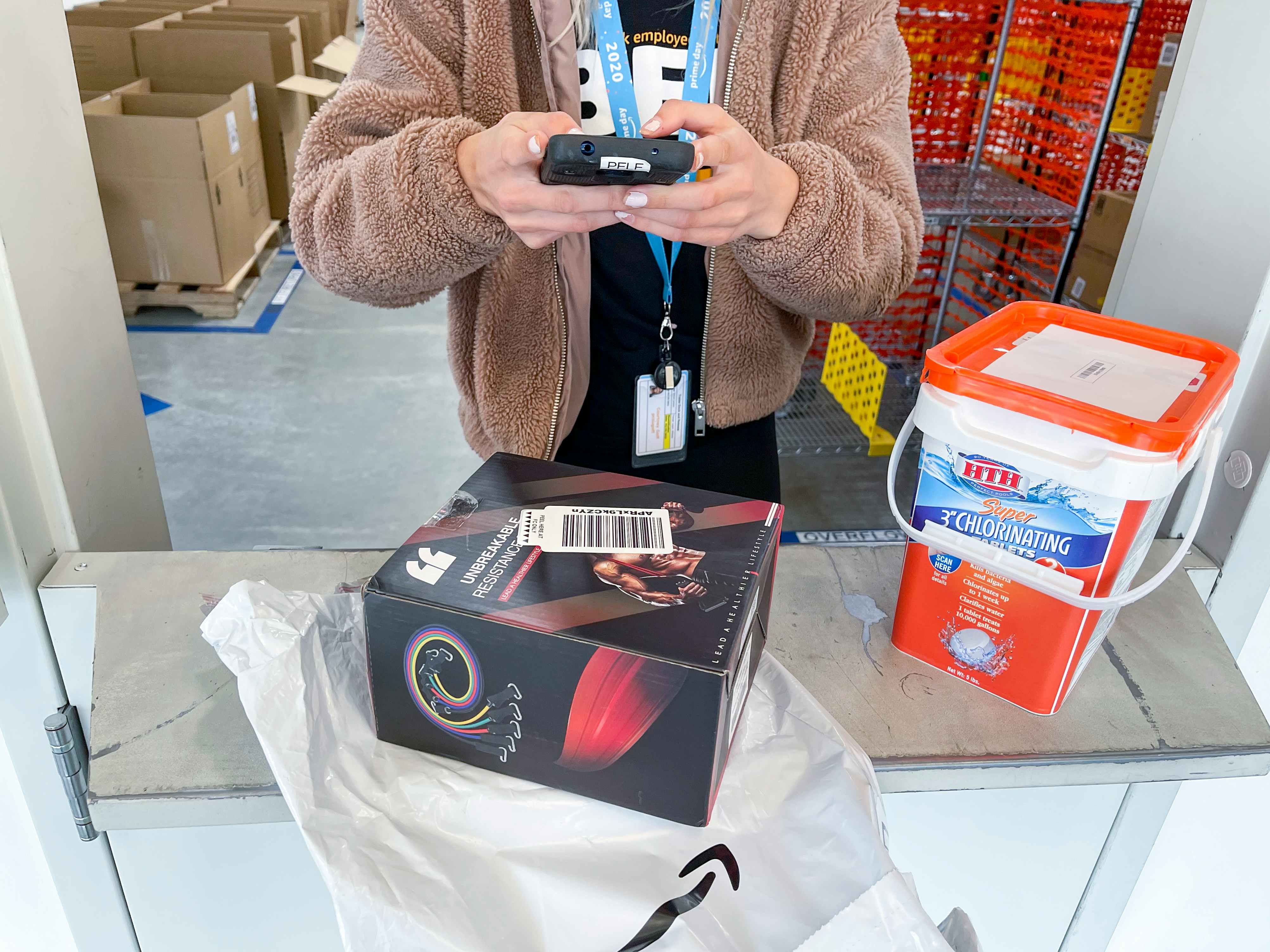 An Amazon employee scanning a return sticker on a product at an Amazon hub location