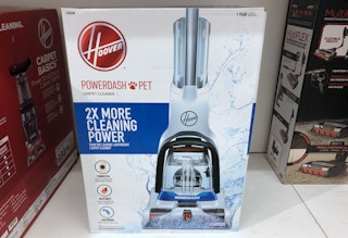A Hoover Powerdash vacuum in its box sitting on a shelf at Kohl's.