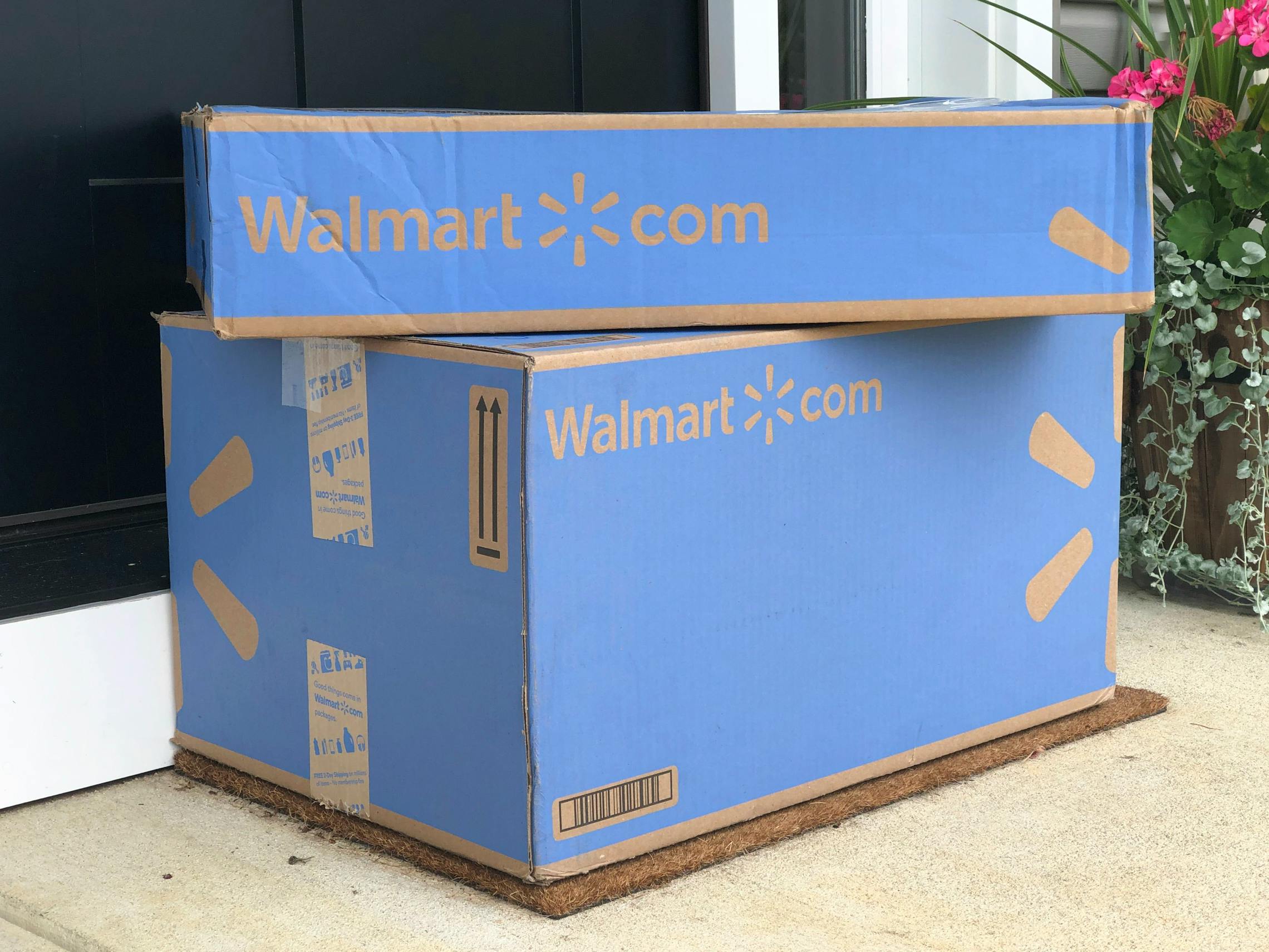 Two Walmart boxes on a doorstep
