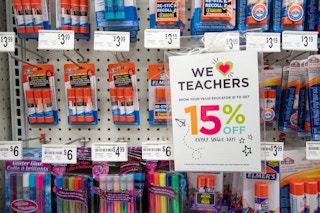 A sign on a wall display at Michaels that says "We love teachers" offering 15% off every day with a valid educator ID.