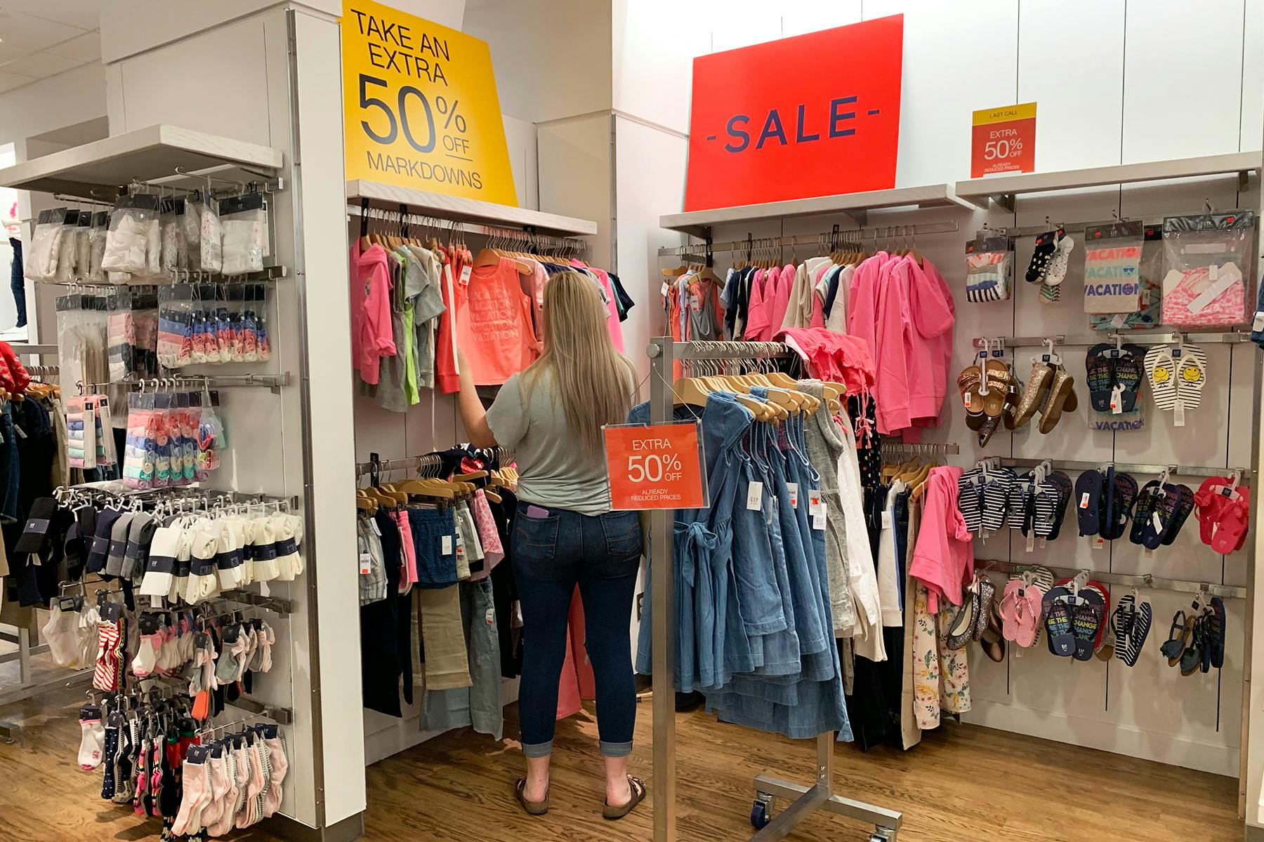 Someone shopping in a sale section in a GAP store