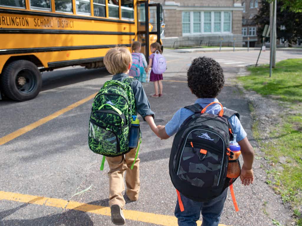two kids walking together wearing High Sierra backpacks